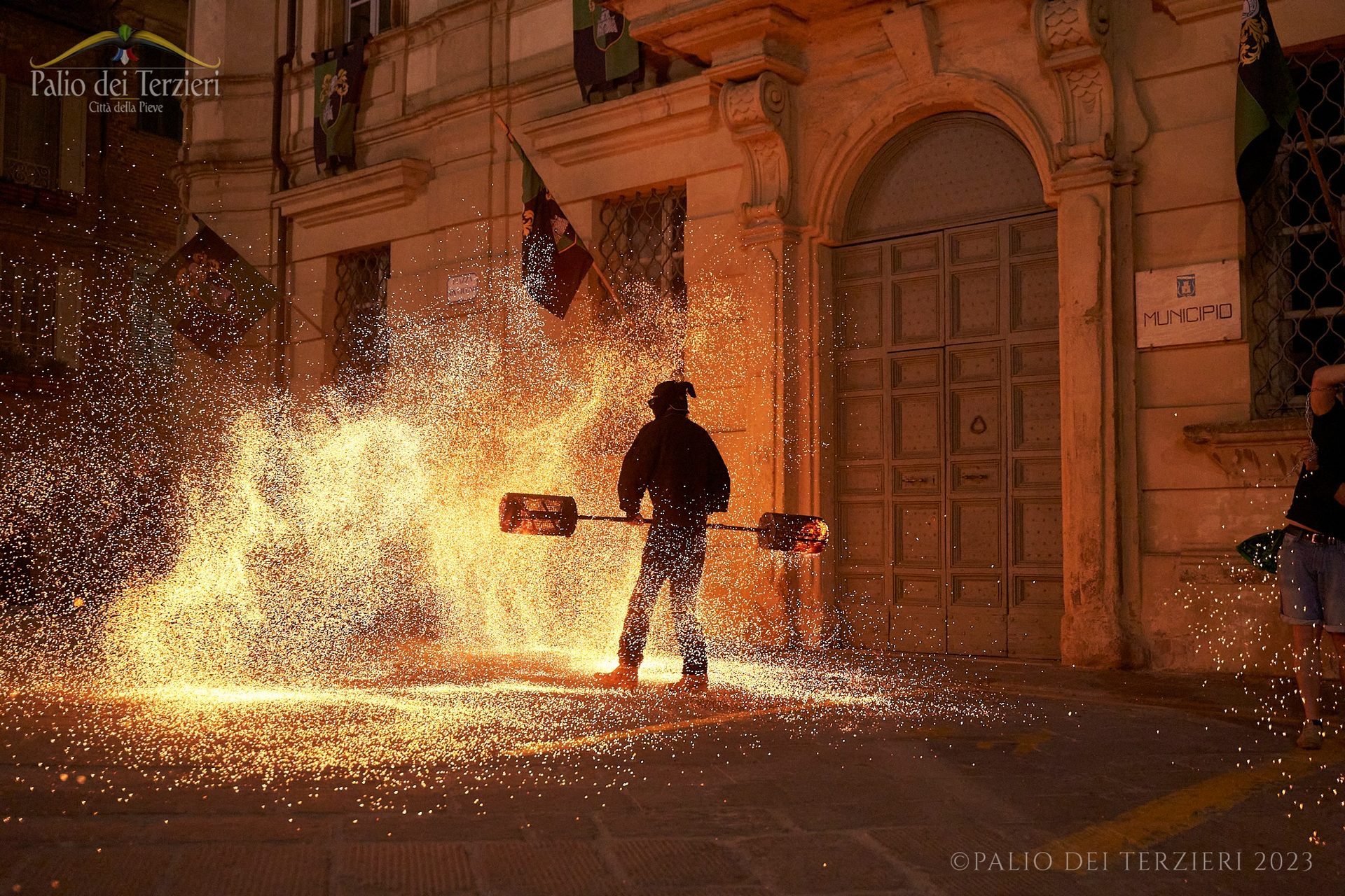 Nighttime fire-breathing performance in the old town streets during the Palio dei Terzieri of Città della Pieve.